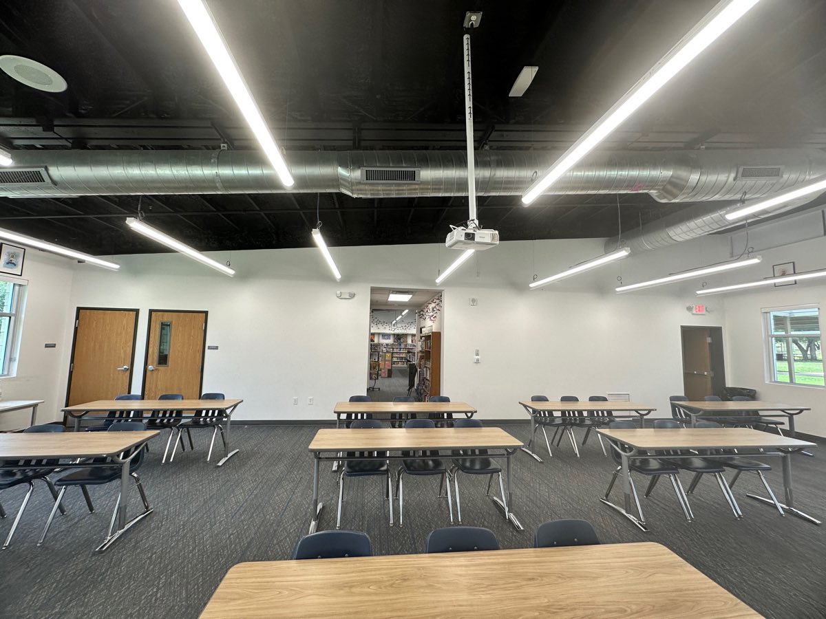 Before: the classroom looking through to the old library, a projector overhead and nothing on the walls.