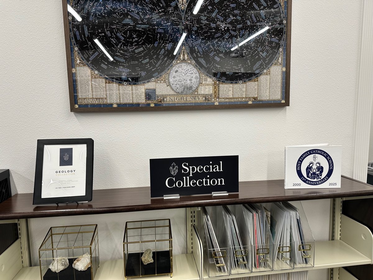 The night sky chart above the Special Collection shelf, the geology collection binder and specimens cased in glass.